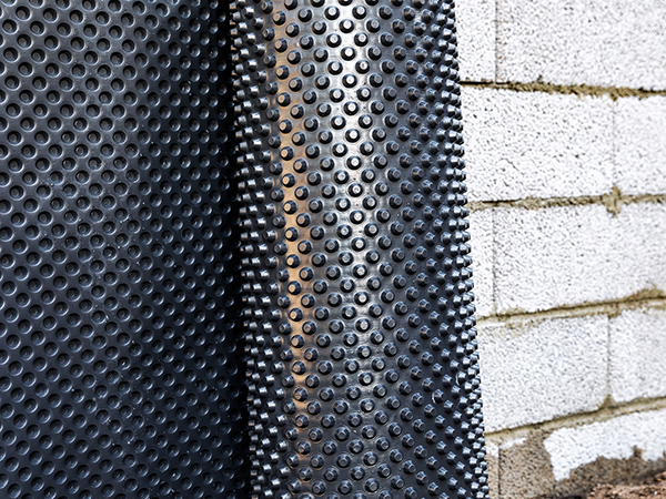 Crawlspace wall waterproofing - installing dimple geomembrane