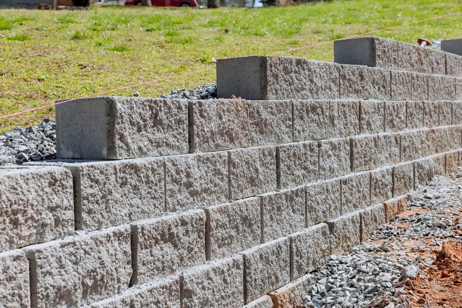 Retaining wall is being built as part of construction new home near property where wall is to be built